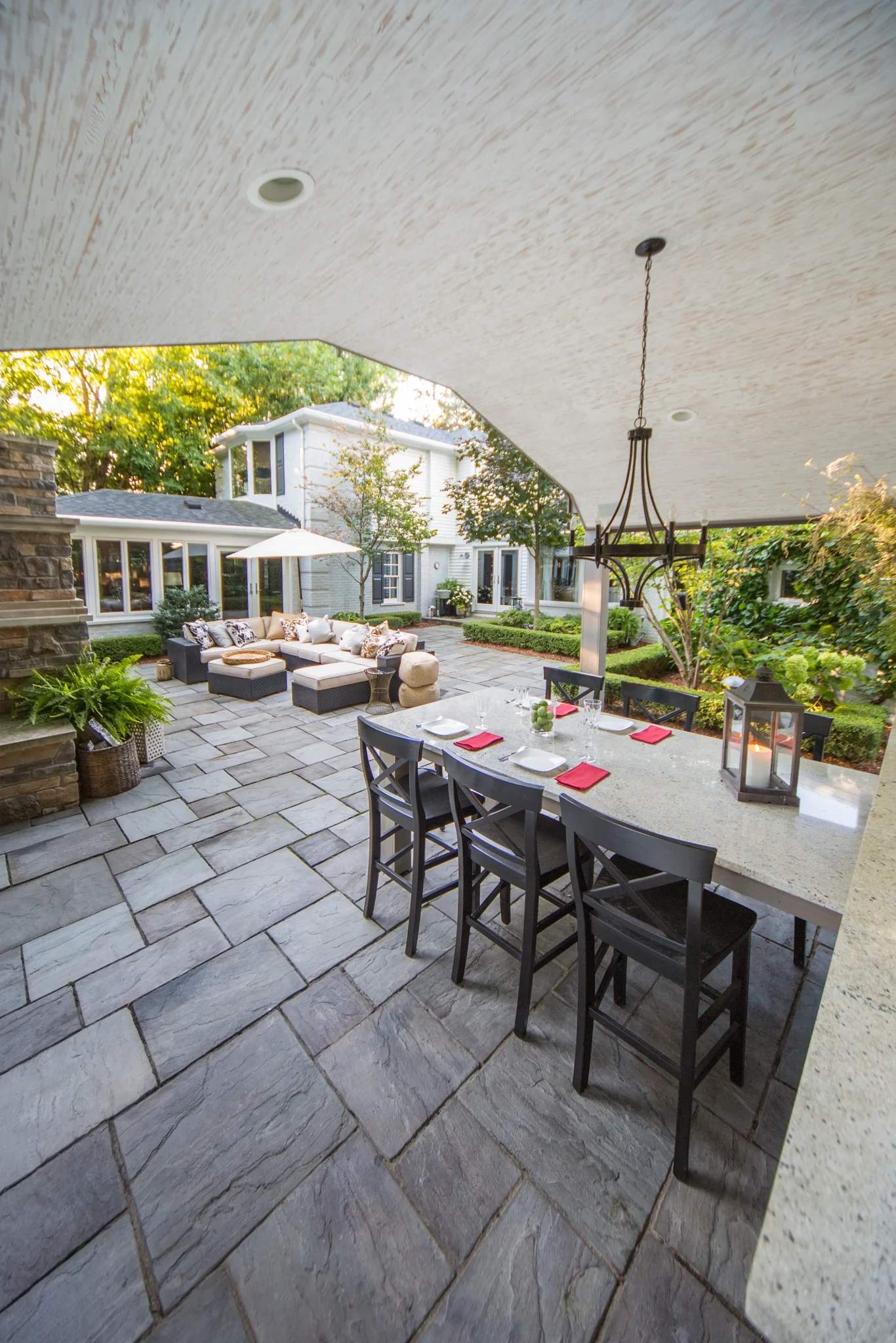 Well landscaped home's backyard patio area