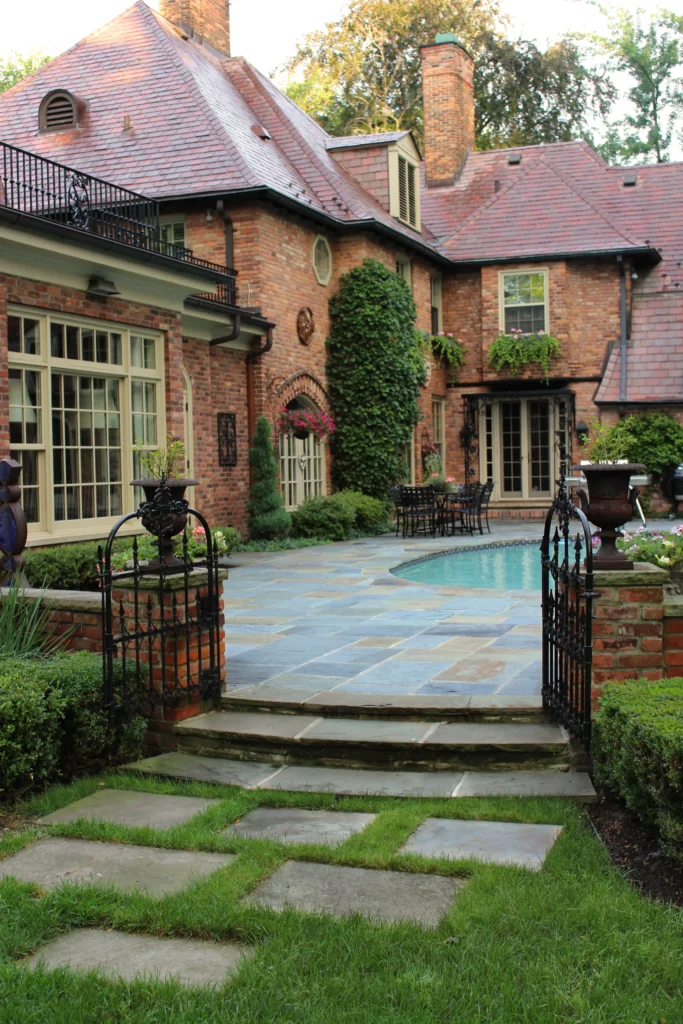 Brick walls with gate to outdoor inground pool